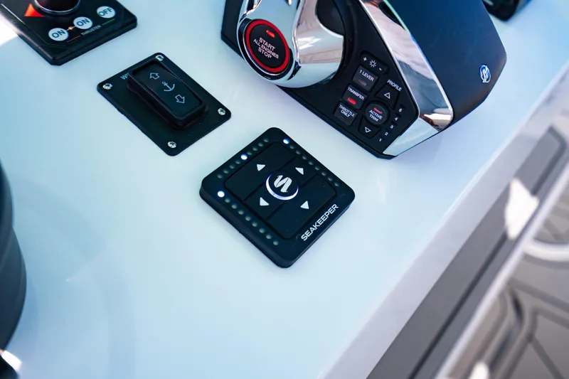 Slide: The Image of Control panel of 2026 Reef Runner 340 boat featuring Seakeeper and throttle controls. - 16