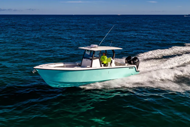 Slide: The Image of 2026 Reef Runner 340 boat cruising on open ocean waters. - 2