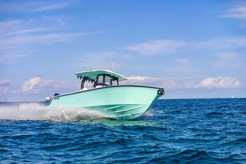 Slide: The Image of 2026 Reef Runner 340 boat cruising on open ocean under clear blue sky. - 29