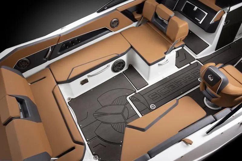 Slide: The Image of 2026 Scarab 285 LX Wake boat interior with brown seating and sleek design. - 12