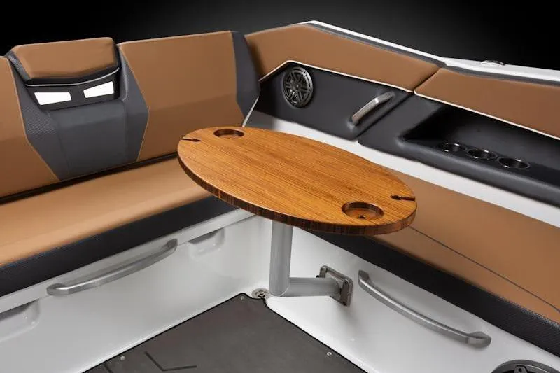 Slide: The Image of Interior of 2026 Scarab 285 LX Wake boat with wooden table and cushioned seating. - 13