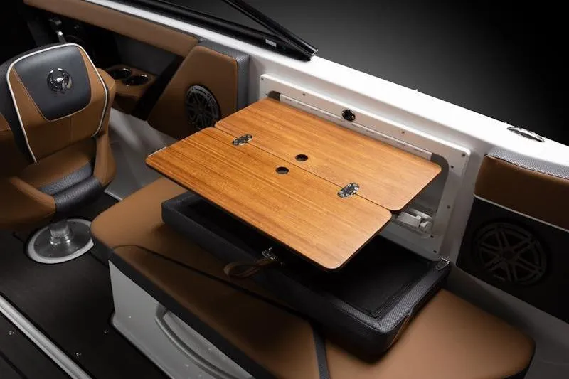 Slide: The Image of 2026 Scarab 285 LX Wake boat interior with foldable wooden table and seating. - 14