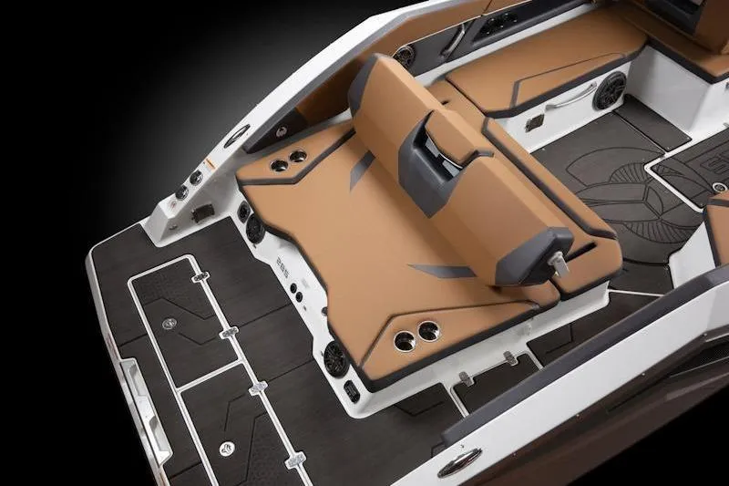 Slide: The Image of 2026 Scarab 285 LX Wake boat interior with tan and black seating, cup holders, and sleek design. - 15