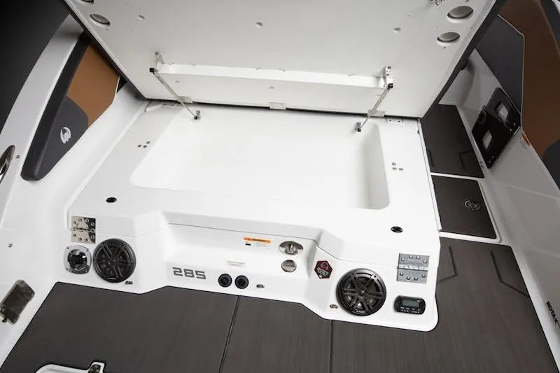 Slide: The Image of 2026 Scarab 285 LX Wake boat interior with storage compartment and audio system. - 16