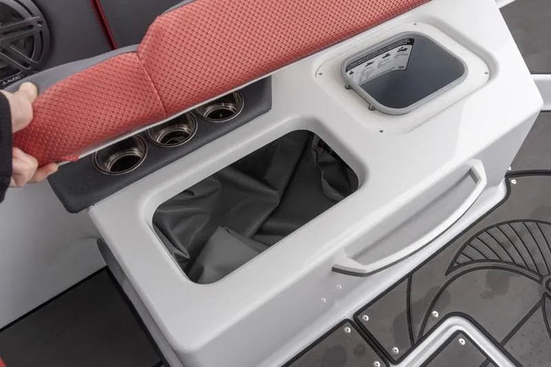 Slide: The Image of Interior storage compartment of 2026 Scarab 285 LX Wake boat with red seat cushion. - 22