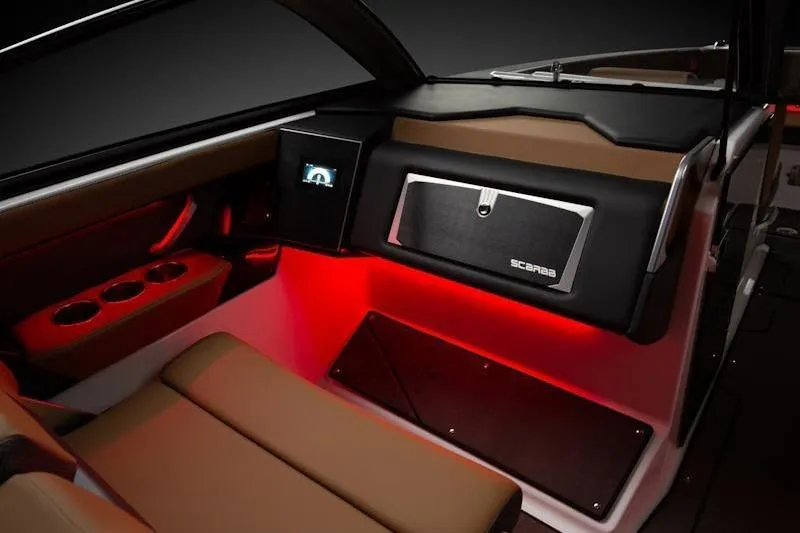 Slide: The Image of 2026 Scarab 285 LX Wake boat interior with ambient red lighting and modern dashboard. - 8