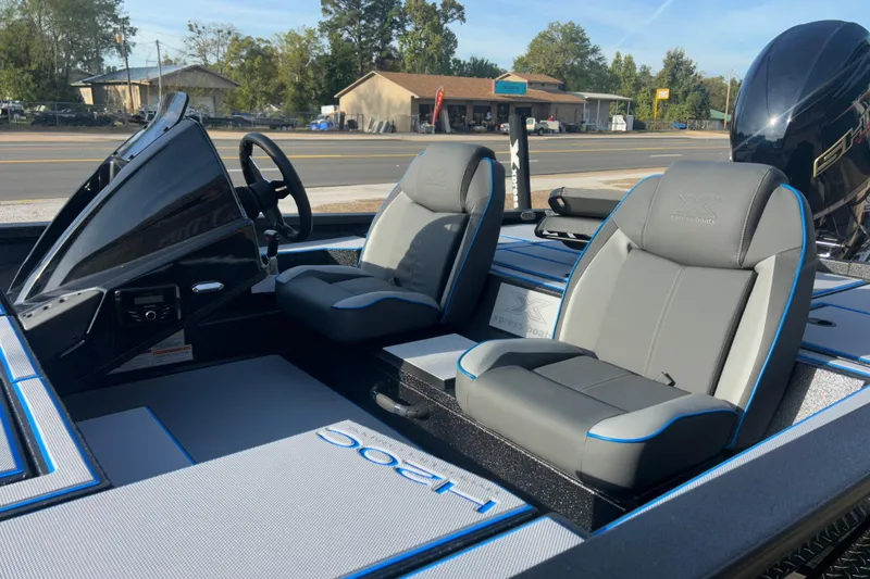 Slide: The Image of 2026 Xpress H20C Crappie boat interior with dual seats and steering console. - 5