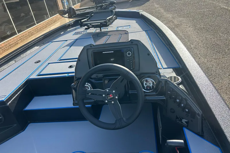Slide: The Image of 2026 Xpress H20C Crappie boat interior with steering wheel and control panel. - 8