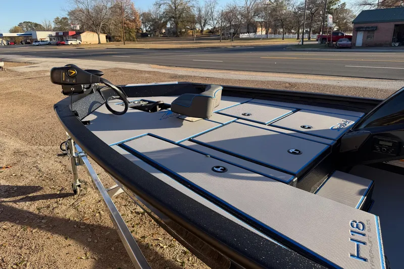 Slide: The Image of 2026 Xpress H18 boat with sleek deck design, parked on roadside. - 5
