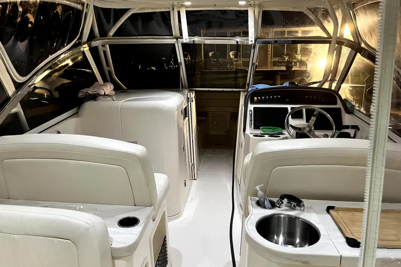 Slide: The Image of 2017 Grady-White Freedom 307 boat interior with helm, seating, and sink. - 6