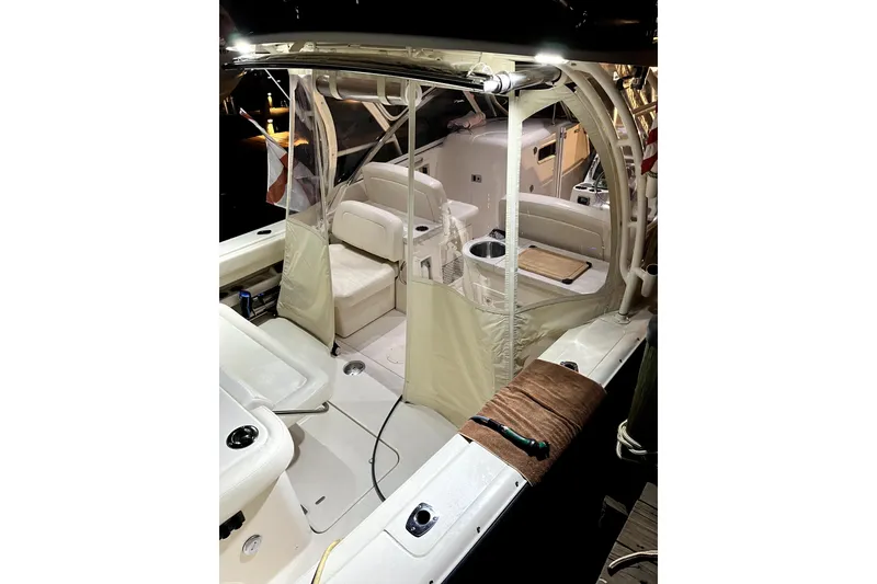 Slide: The Image of 2017 Grady-White Freedom 307 boat interior with seating and protective covers. - 8