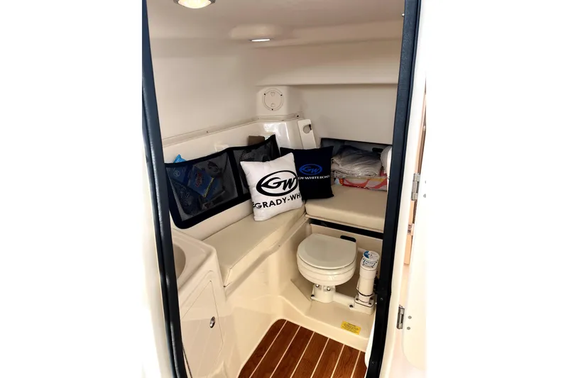 Slide: The Image of 2017 Grady-White Freedom 307 boat interior with toilet and seating area. - 9
