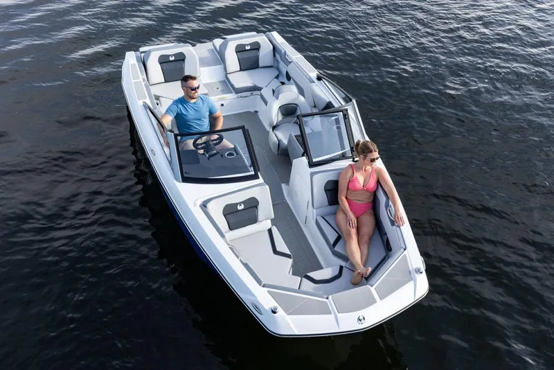 Slide: The Image of Manufacturer Provided Image: 2026 Scarab 210 SE boat on water with two passengers enjoying a sunny day. - 3