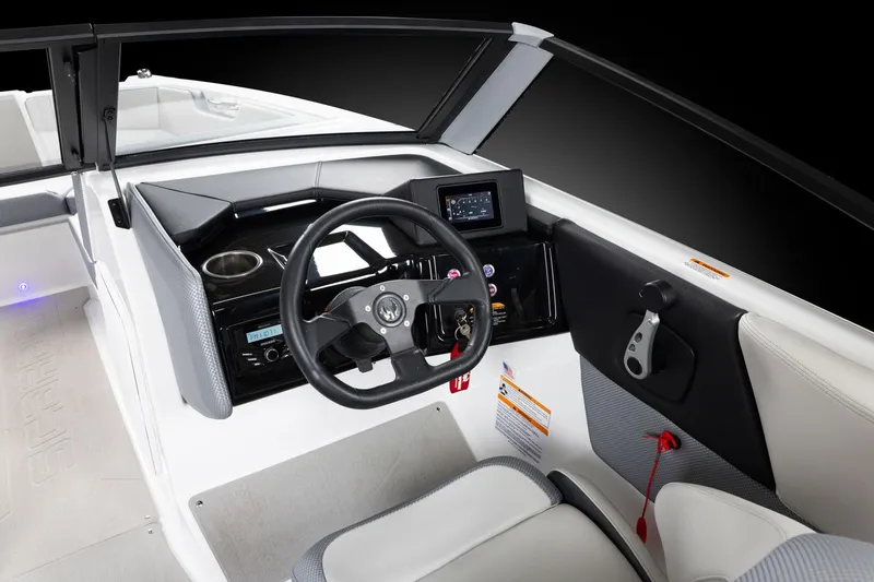 Slide: The Image of Manufacturer Provided Image: 2026 Scarab 210 SE boat interior with steering wheel and dashboard controls. - 5