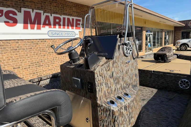 Slide: The Image of 2026 Xpress H210B Bay boat with camouflage design at a marine dealership. - 3