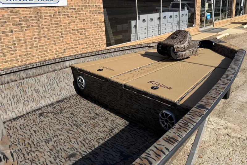 Slide: The Image of 2026 Xpress H210B Bay boat with camo design and SeaDek flooring. - 4