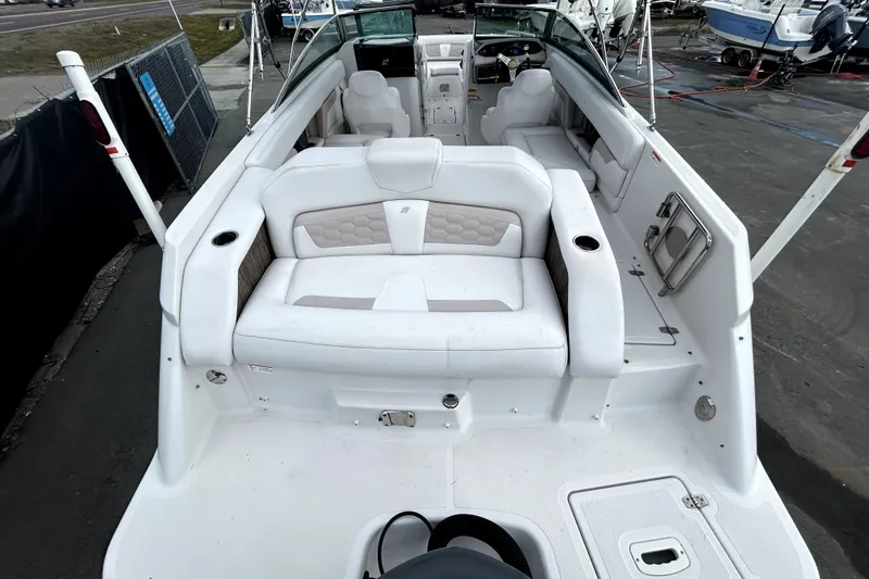 Slide: The Image of 2018 Four Winns HD240 boat interior with white seating and modern design. - 11