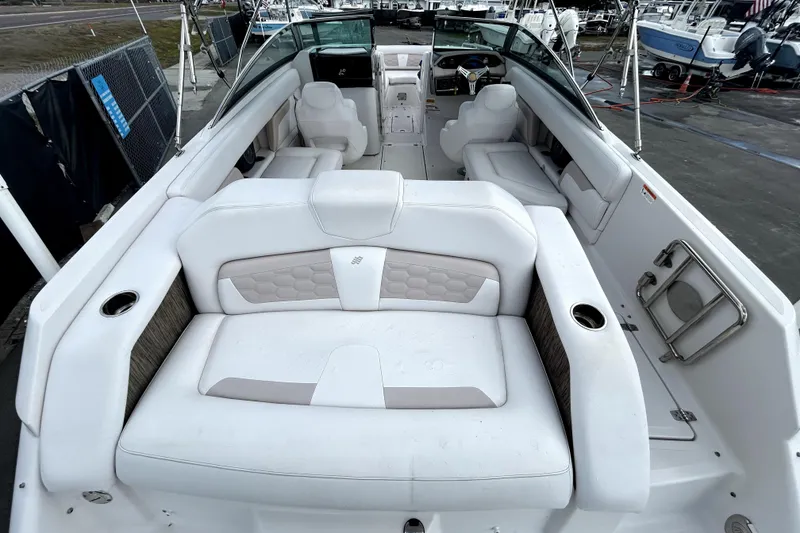 Slide: The Image of 2018 Four Winns HD240 boat interior with white seating and modern design. - 14
