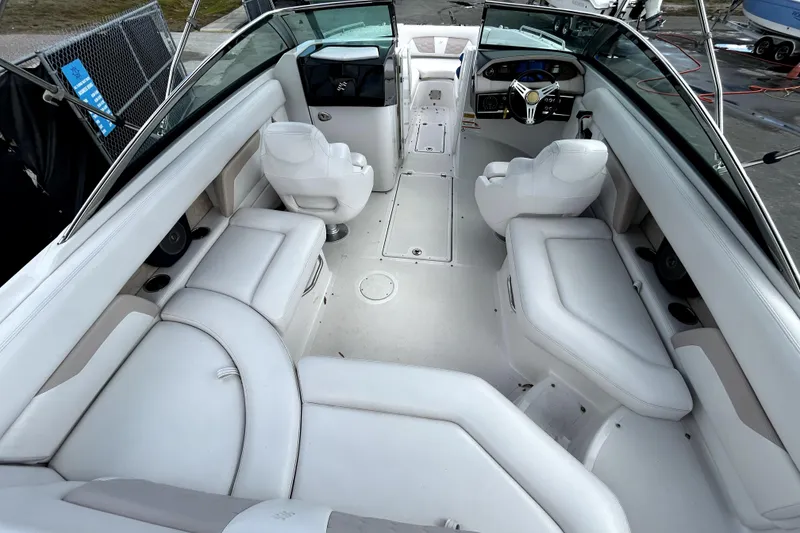 Slide: The Image of 2018 Four Winns HD240 boat interior with white seating and modern dashboard. - 15