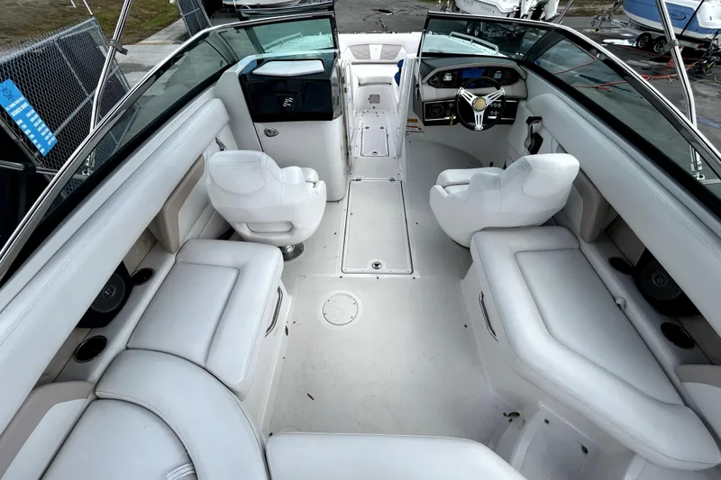 Slide: The Image of 2018 Four Winns HD240 boat interior with white seating and modern dashboard. - 16