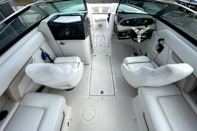 Slide: The Image of 2018 Four Winns HD240 boat interior with white seating and modern dashboard. - 17