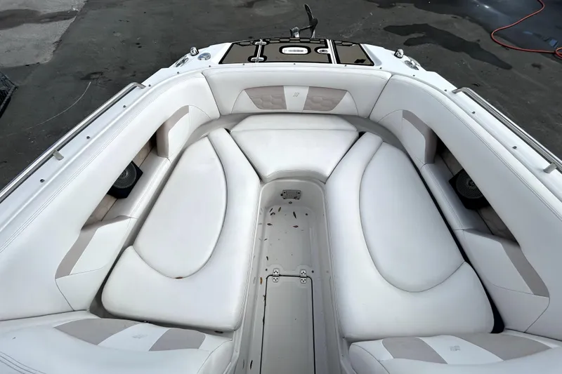 Slide: The Image of 2018 Four Winns HD240 boat interior with white cushioned seating. - 20