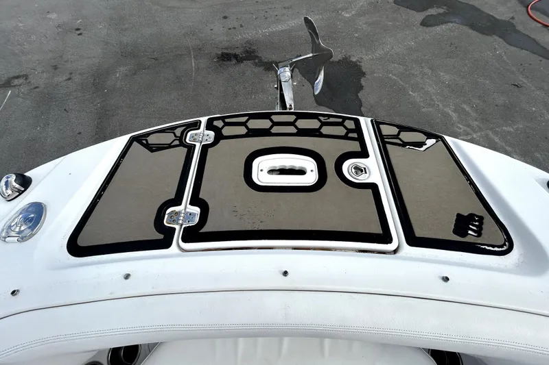 Slide: The Image of 2018 Four Winns HD240 boat deck with anchor and storage compartments. - 21