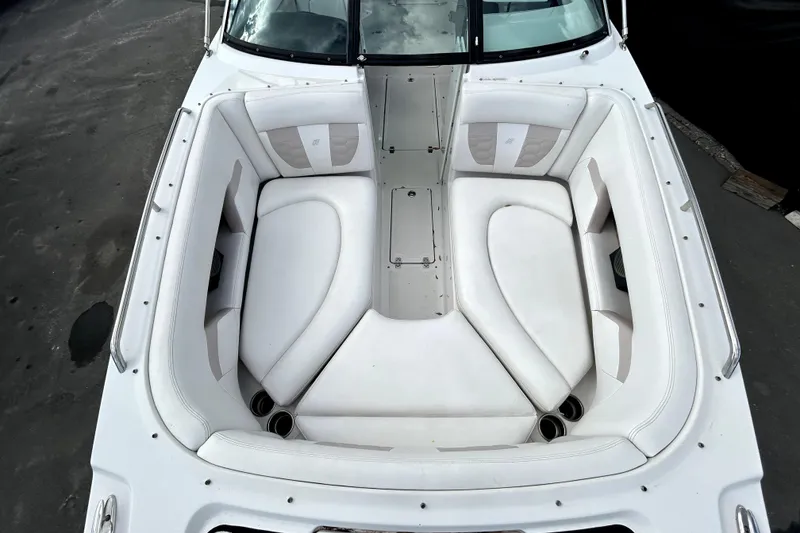 Slide: The Image of 2018 Four Winns HD240 boat with spacious white seating area and cup holders. - 24