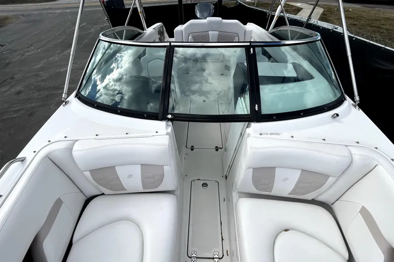Slide: The Image of 2018 Four Winns HD240 boat interior with white seating and glass windshield. - 25
