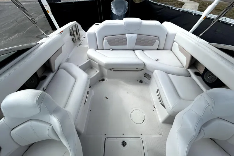 Slide: The Image of 2018 Four Winns HD240 boat interior with white seating and spacious layout. - 28