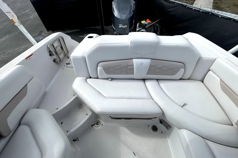 Slide: The Image of 2018 Four Winns HD240 boat interior with white seating and a 250 HP engine. - 29