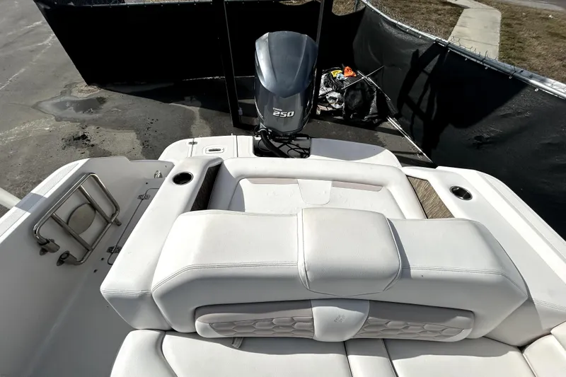 Slide: The Image of 2018 Four Winns HD240 boat with white seating and 250 horsepower outboard motor. - 30
