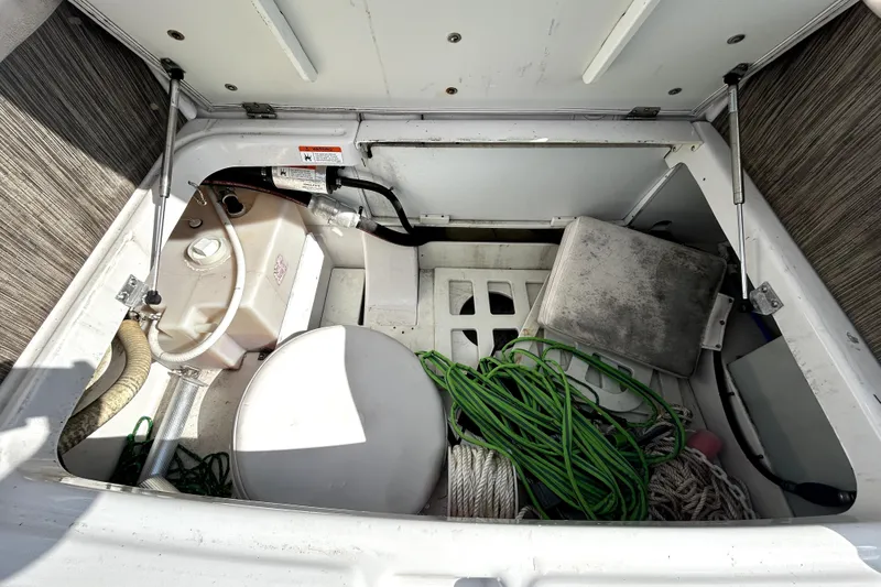 Slide: The Image of 2018 Four Winns HD240 boat storage compartment with ropes and equipment. - 37
