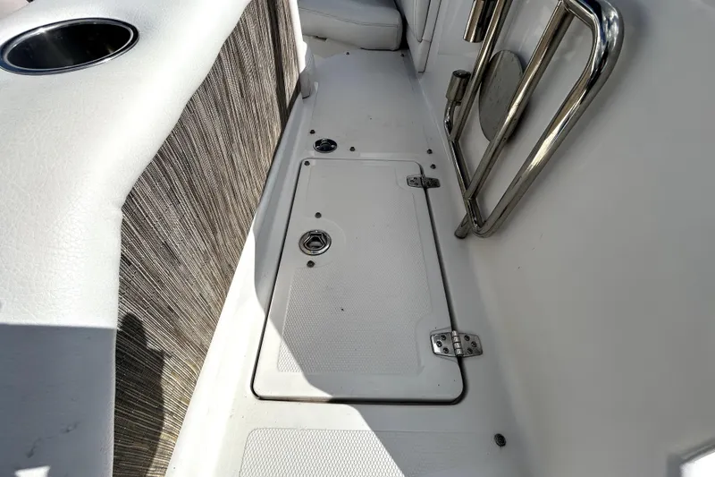 Slide: The Image of 2018 Four Winns HD240 boat interior with storage compartment and stainless steel railing. - 38