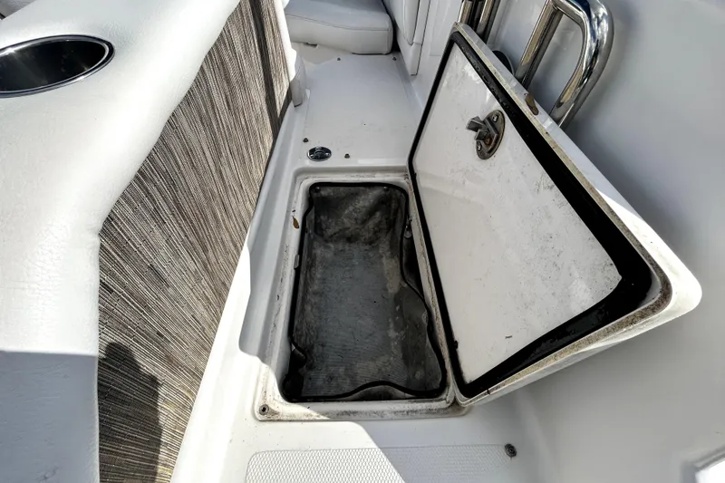 Slide: The Image of Open storage compartment on 2018 Four Winns HD240 boat interior. - 39