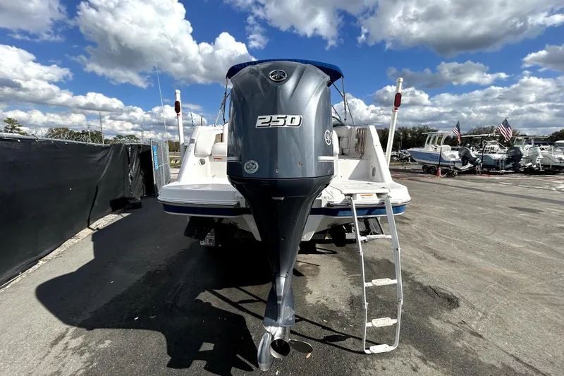 Slide: The Image of 2018 Four Winns HD240 boat with 250 horsepower engine, parked under a cloudy sky. - 4