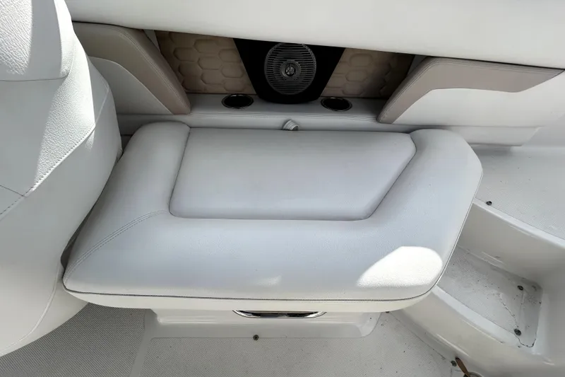 Slide: The Image of 2018 Four Winns HD240 boat interior with white cushioned seating and speaker. - 42