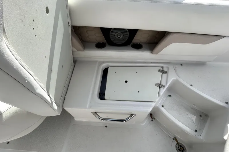 Slide: The Image of 2018 Four Winns HD240 boat interior with storage compartment and speaker. - 43