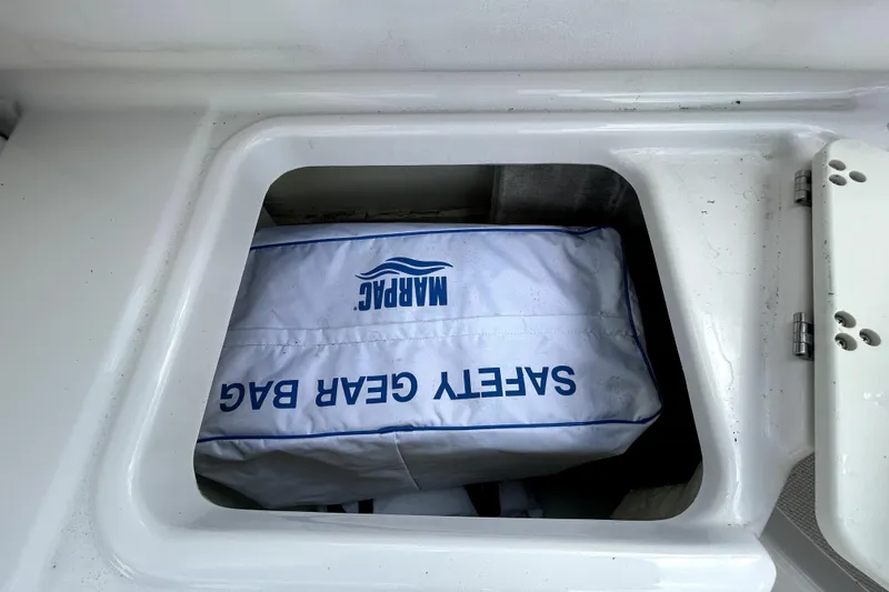 Slide: The Image of Safety gear bag in storage compartment of 2018 Four Winns HD240 boat. - 45