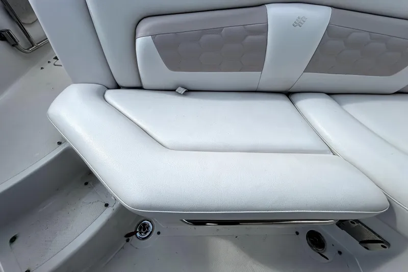 Slide: The Image of 2018 Four Winns HD240 boat interior with white cushioned seating. - 46