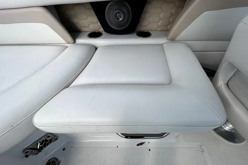 Slide: The Image of 2018 Four Winns HD240 boat interior with white cushioned seating and speaker. - 54