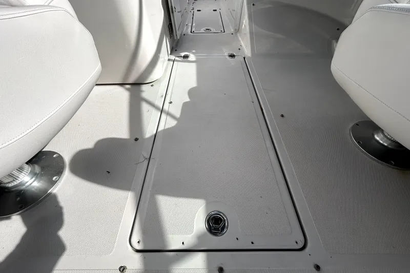 Slide: The Image of Interior view of 2018 Four Winns HD240 boat, featuring clean white seating and flooring. - 57