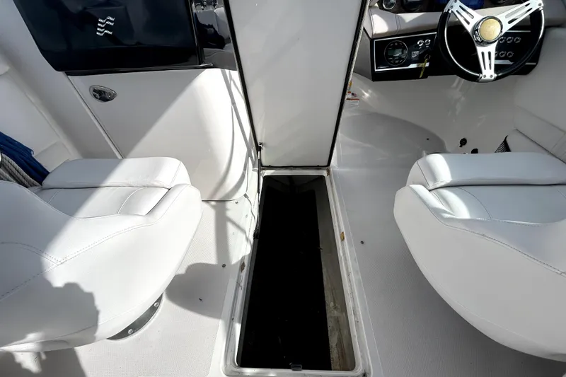 Slide: The Image of Interior of 2018 Four Winns HD240 boat showing seating and steering wheel. - 58