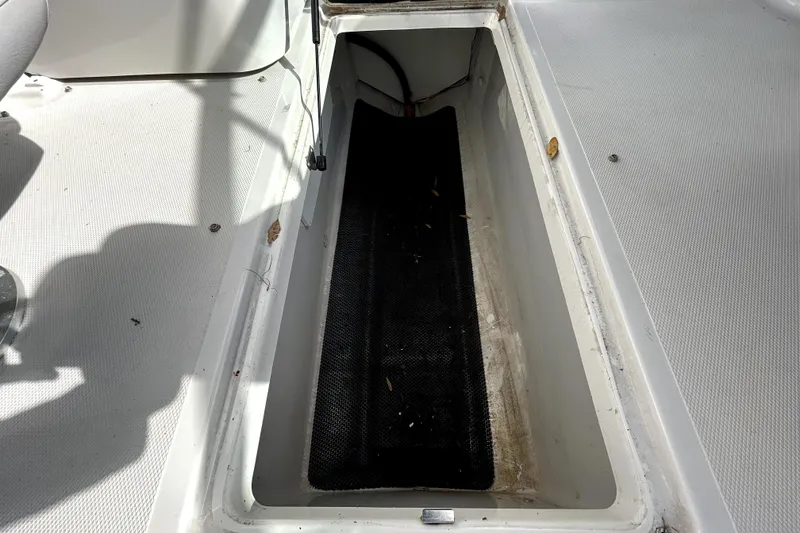 Slide: The Image of Storage compartment on 2018 Four Winns HD240 boat, featuring a clean, spacious interior. - 59