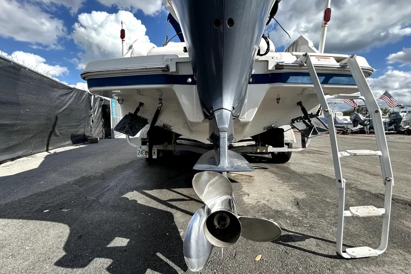 Slide: The Image of 2018 Four Winns HD240 boat with Yamaha outboard motor on trailer under cloudy sky. - 6