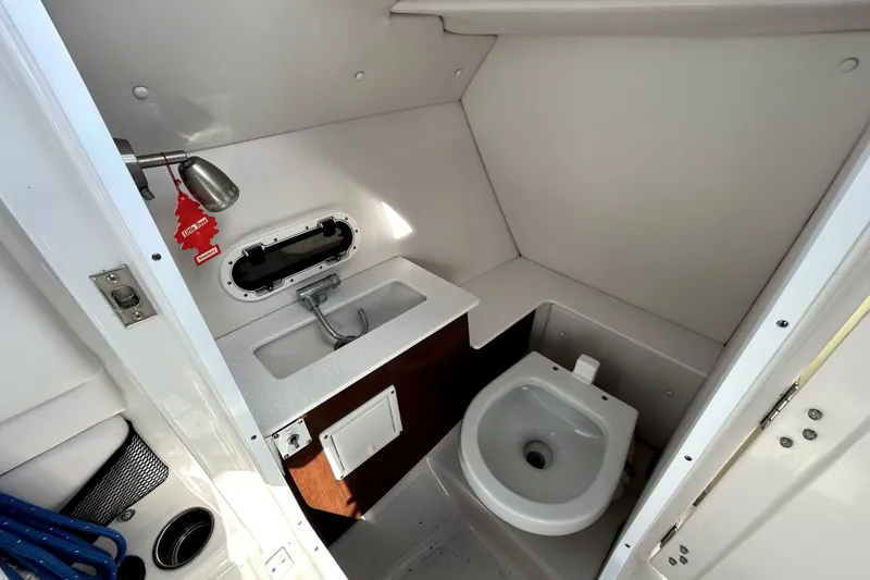 Slide: The Image of 2018 Four Winns HD240 boat bathroom with sink, toilet, and window. - 62