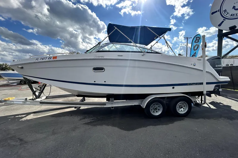 Slide: The Image of 2018 Four Winns HD240 boat on trailer under cloudy sky. - 7