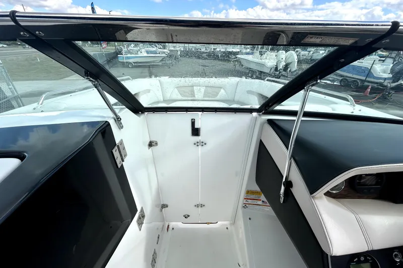 Slide: The Image of 2018 Four Winns HD240 boat interior with windshield and seating area. - 72