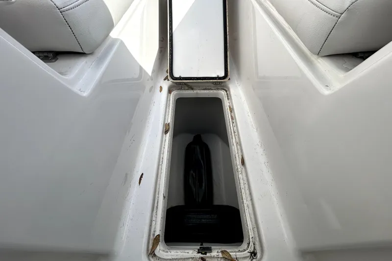 Slide: The Image of 2018 Four Winns HD240 boat storage compartment with leaves inside. - 74