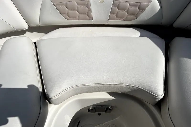 Slide: The Image of 2018 Four Winns HD240 boat interior seating with light upholstery and hexagonal pattern. - 79